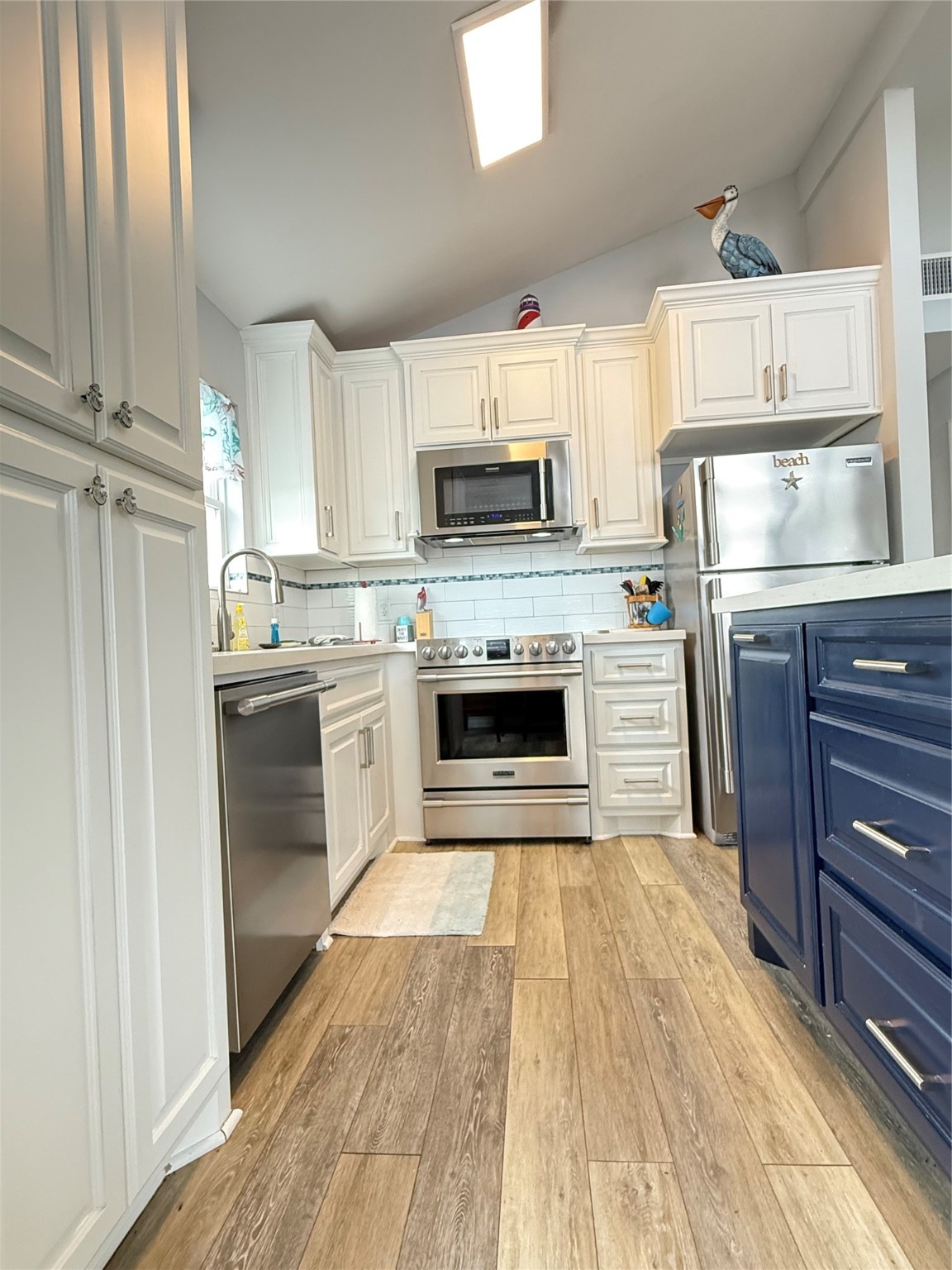 925 Honeysuckle Crystal Beach, TX 77650 - Photo 9 of 20 a kitchen with a stove top oven and refrigerator
