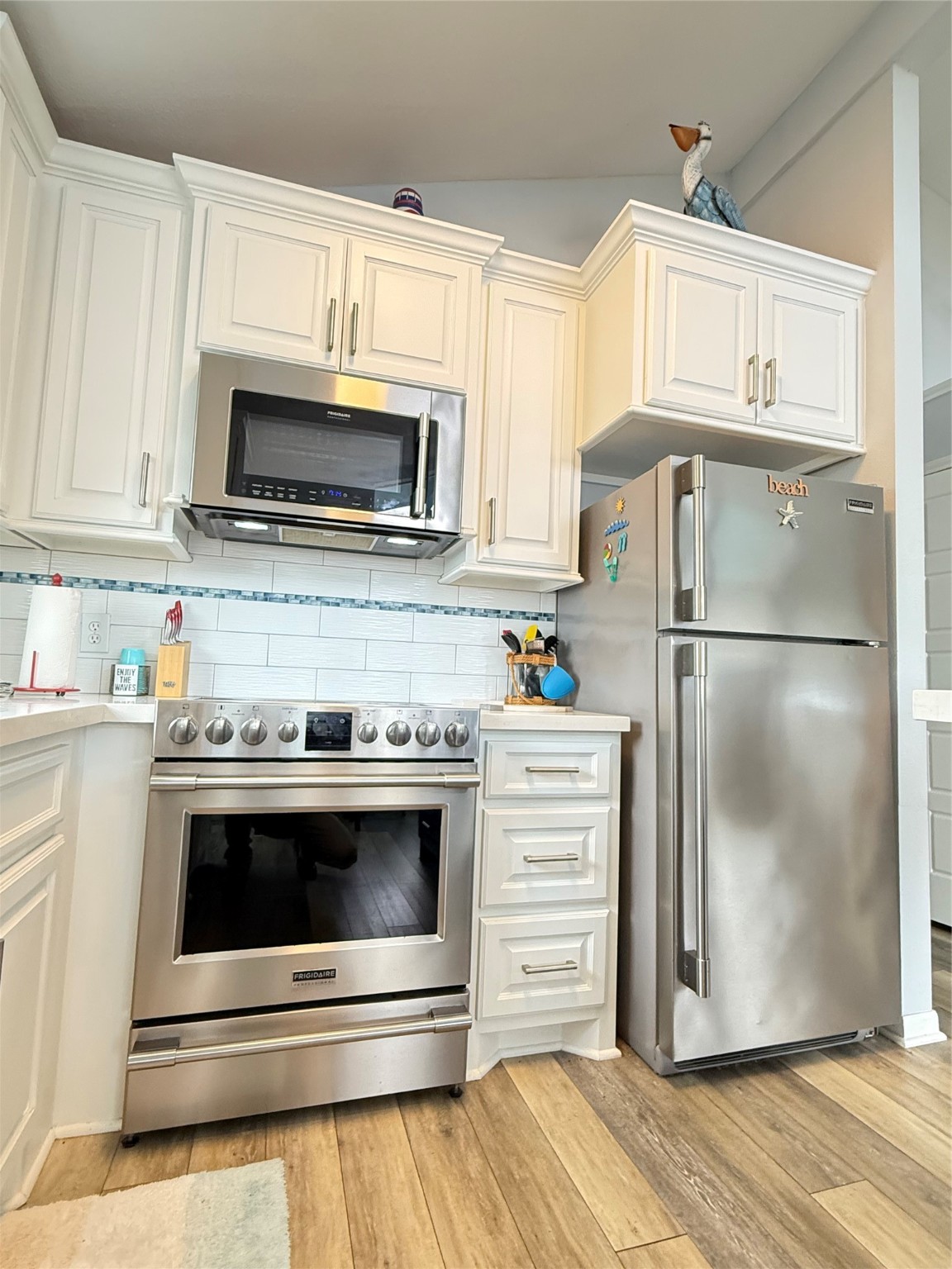925 Honeysuckle Crystal Beach, TX 77650 - Photo 10 of 20 a kitchen with stainless steel appliances a stove a microwave and a refrigerator