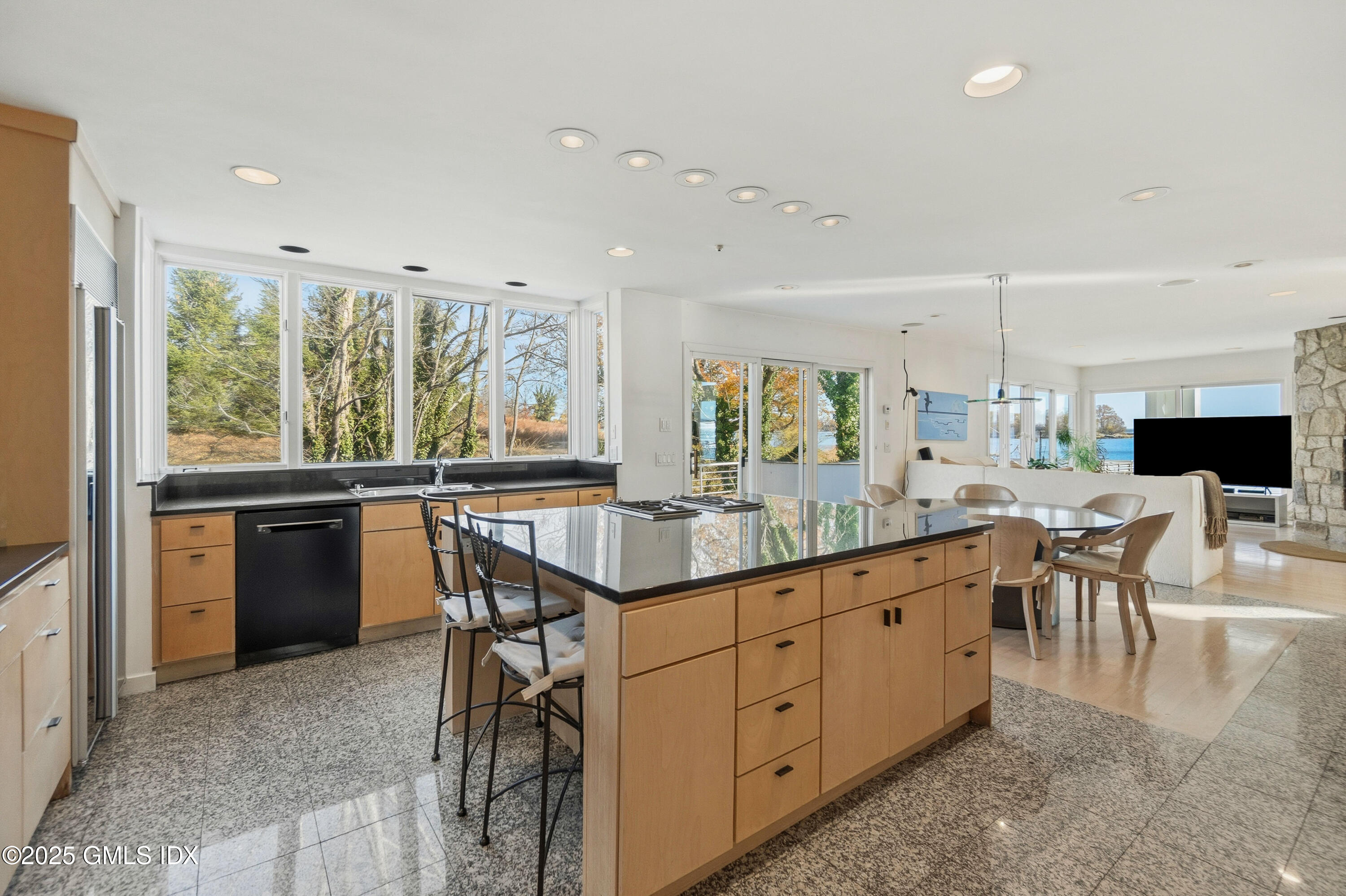 111 Byram Shore Road Greenwich, CT 06830 - Photo 9 of 23 a kitchen with stainless steel appliances granite countertop sink stove and white cabinets