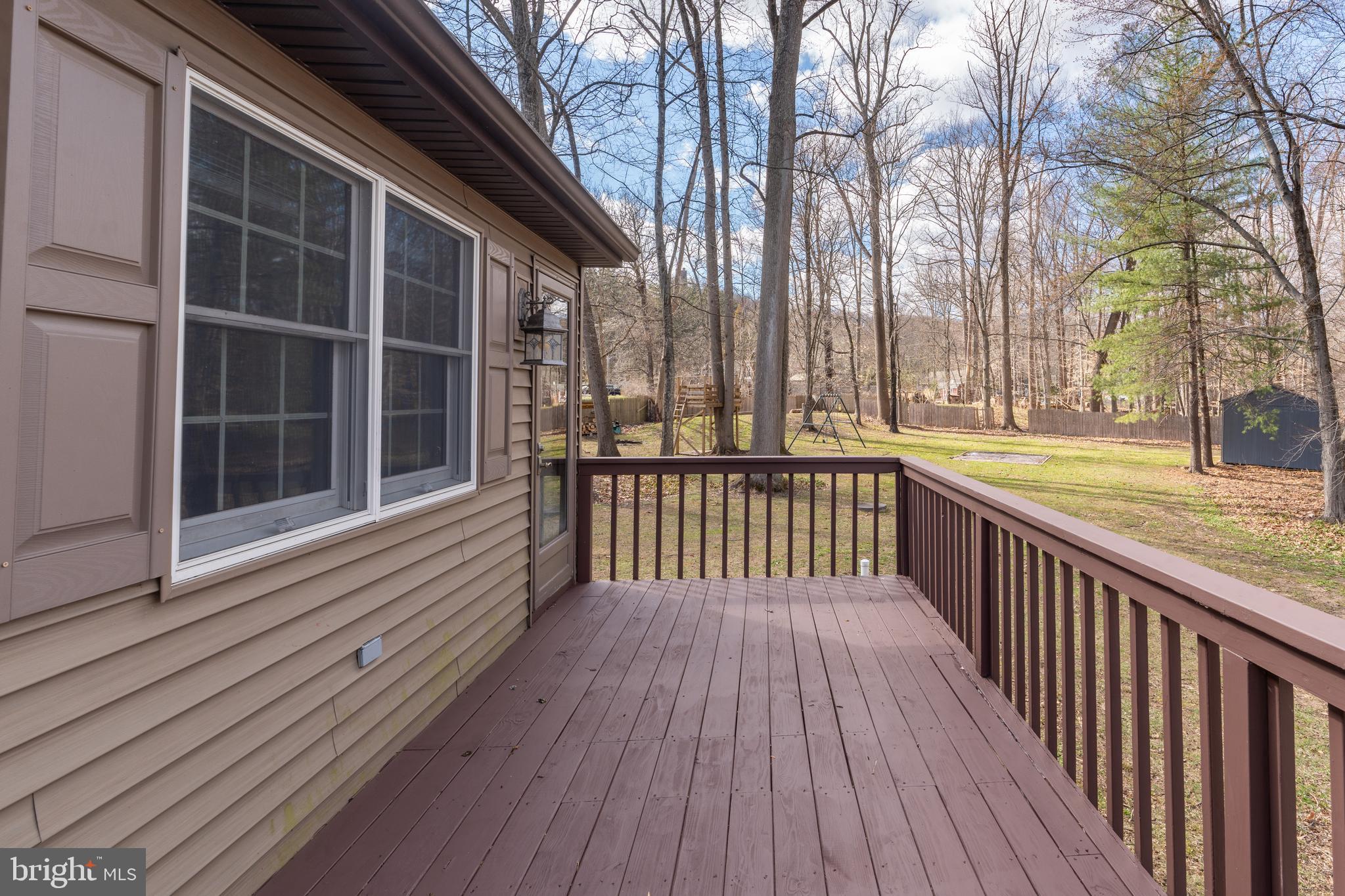 1596 River Road New Hope, PA 18938 - Photo 16 of 39 a view of balcony with wooden floor and fence and a trees