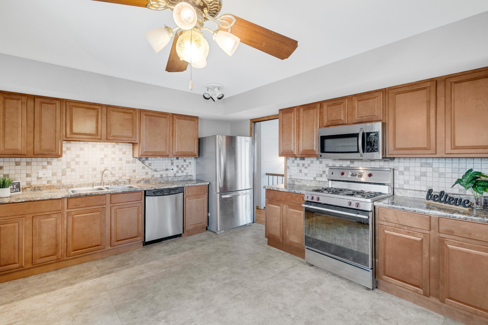 218 Downing Drive Bloomingdale, IL 60108 - Photo 4 of 16 a kitchen with a sink stove and microwave