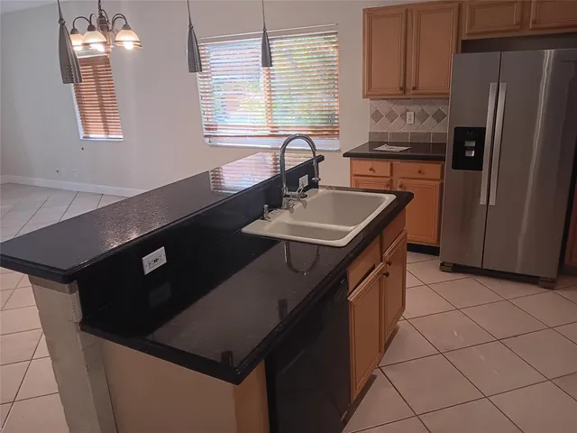 a kitchen that has a sink and a stove