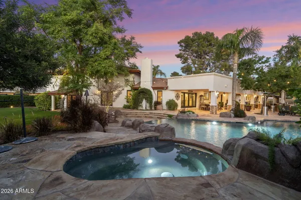 a view of a house with pool and sitting area