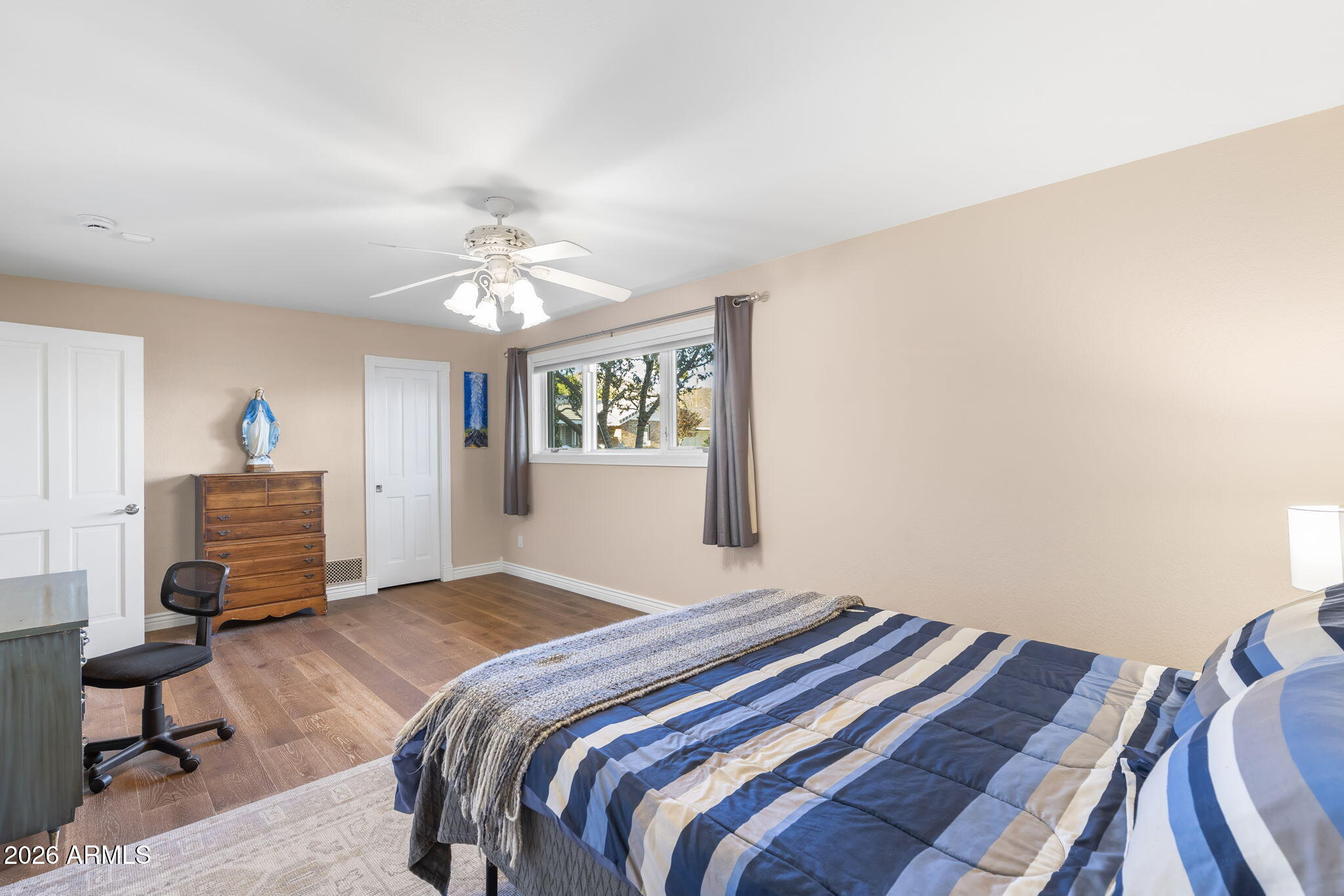 4945 East Cheery Lynn Road Phoenix, AZ 85018 - Photo 15 of 41 a bedroom with a bed and a chandelier