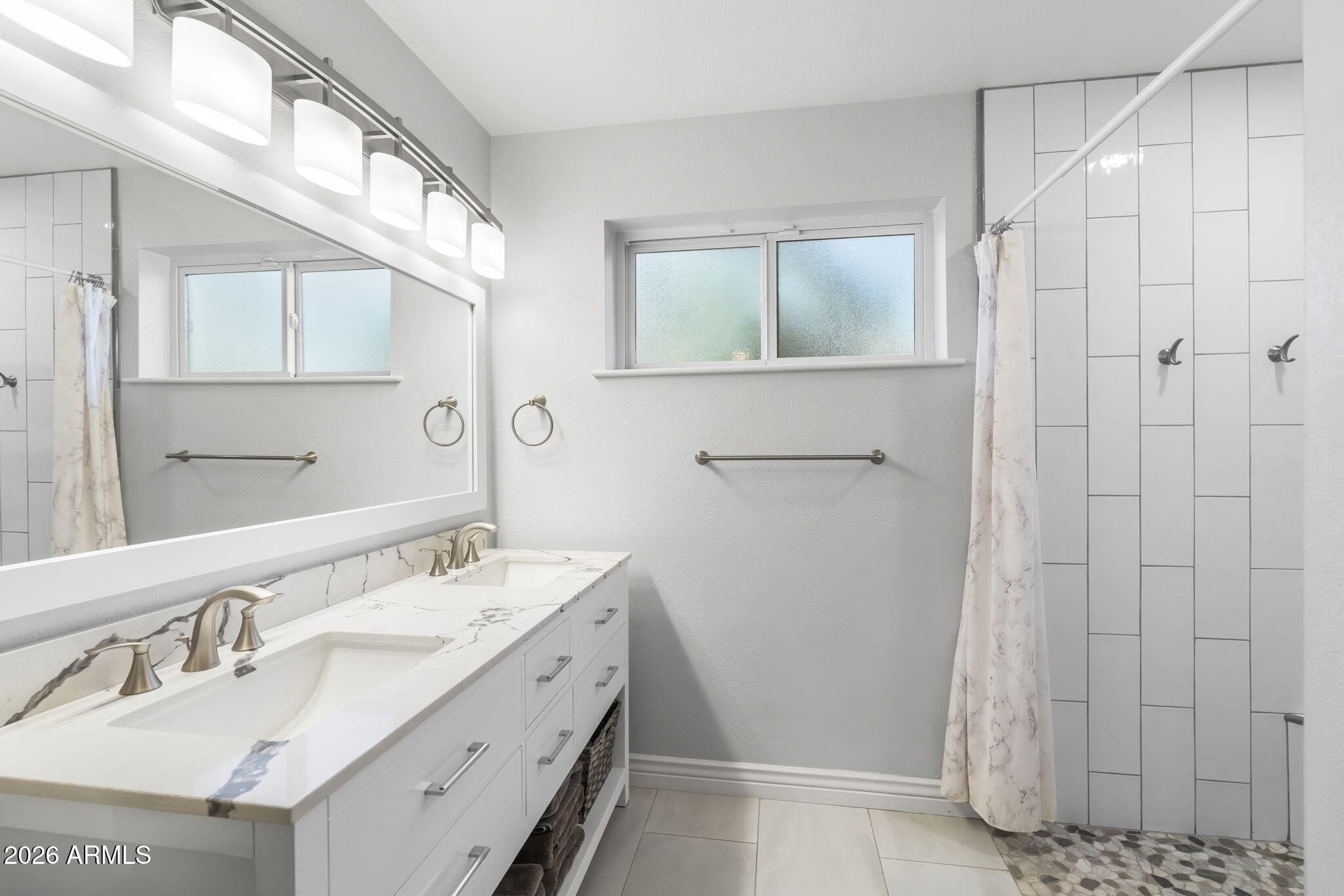 4945 East Cheery Lynn Road Phoenix, AZ 85018 - Photo 16 of 41 a bathroom with a double vanity sink and a mirror