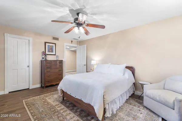 a bedroom with a large bed and a window