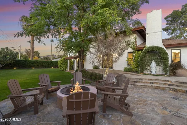 a patio with couches table and chairs and potted plants