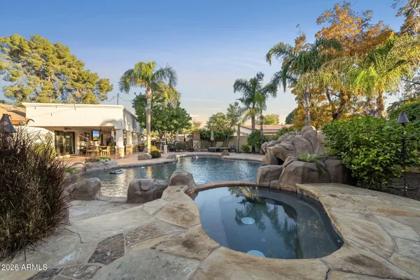a view of a backyard with swimming pool