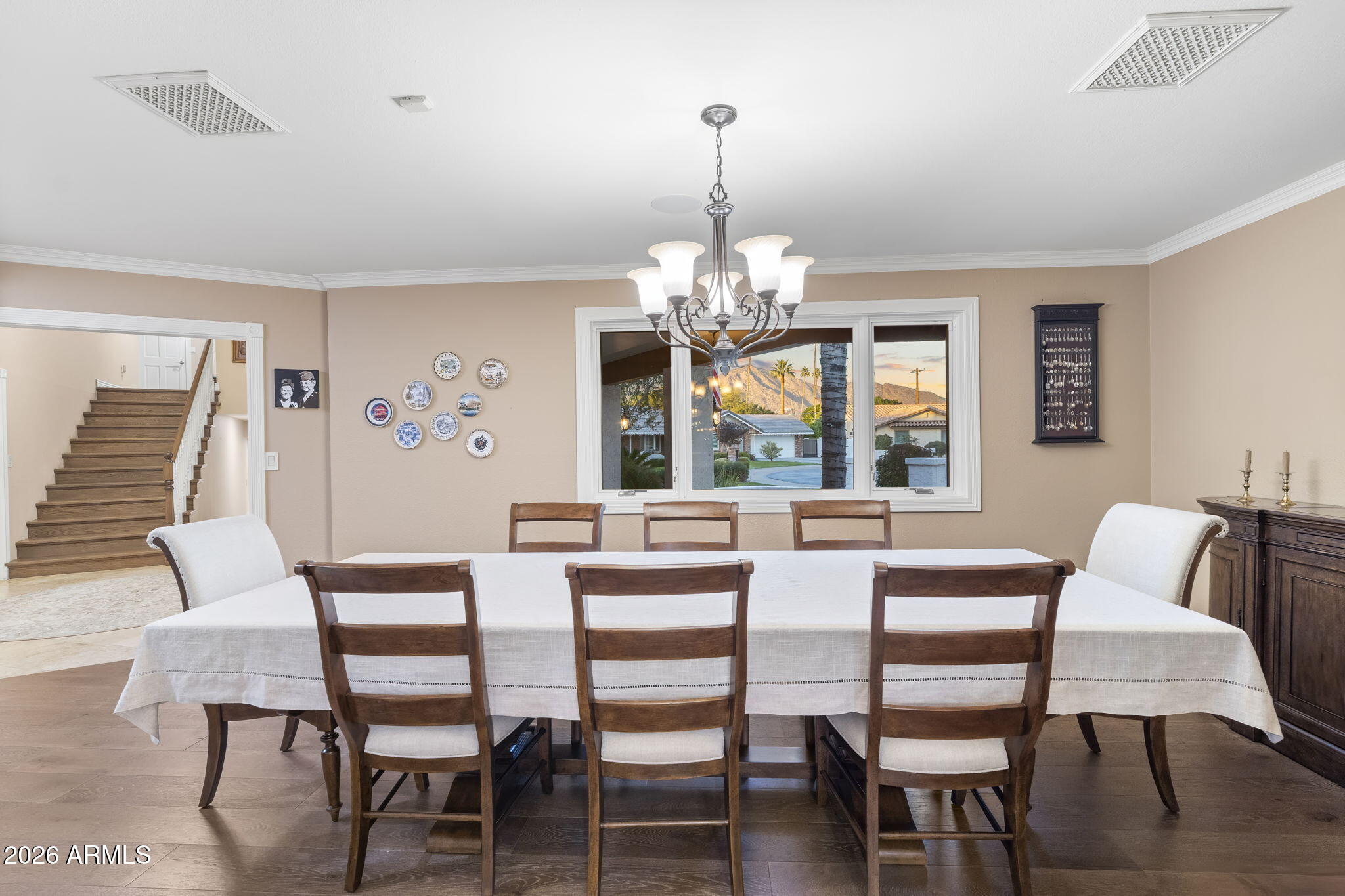 4945 East Cheery Lynn Road Phoenix, AZ 85018 - Photo 4 of 41 a dining room with furniture a chandelier and wooden floor
