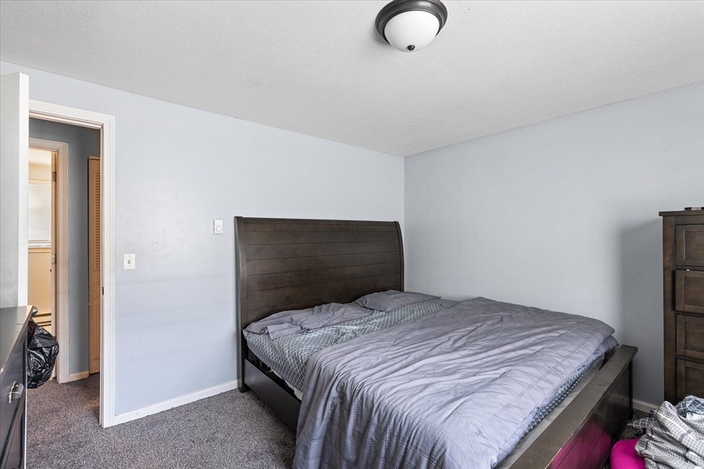 193-195 Nottingham Street Springfield, MA 01104 - Photo 12 of 24 a bedroom with a bed and walk in closet