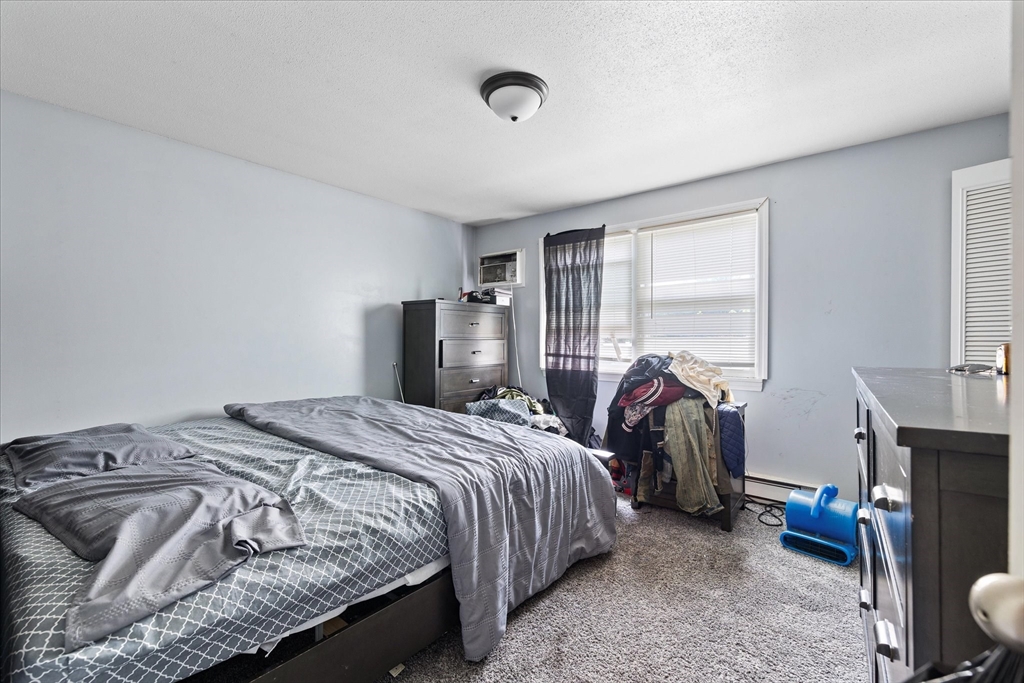 193-195 Nottingham Street Springfield, MA 01104 - Photo 13 of 24 a bedroom with a bed and a tv