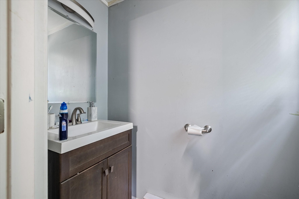 193-195 Nottingham Street Springfield, MA 01104 - Photo 7 of 24 a bathroom with a sink and a mirror