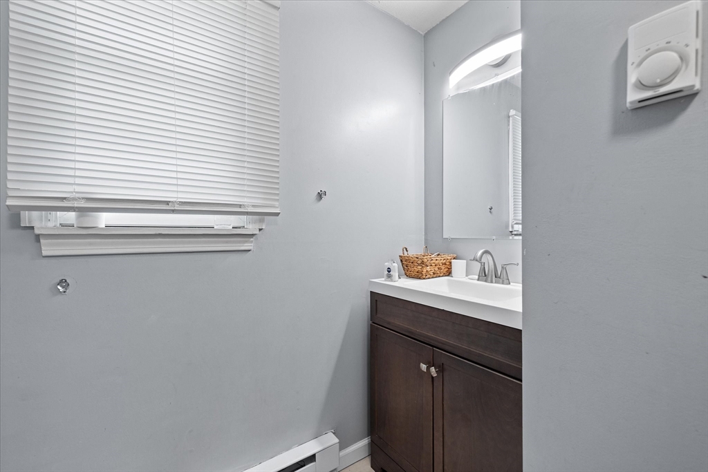 193-195 Nottingham Street Springfield, MA 01104 - Photo 9 of 24 a bathroom with a sink and a mirror