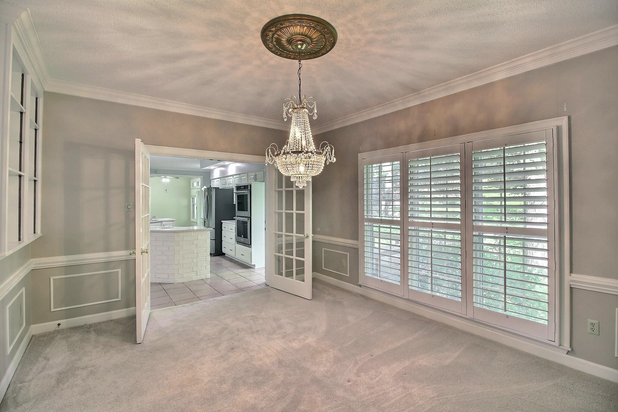 8222 Dogwood Road Germantown, TN 38139 - Photo 14 of 40 a view of a livingroom with a chandelier furniture and windows