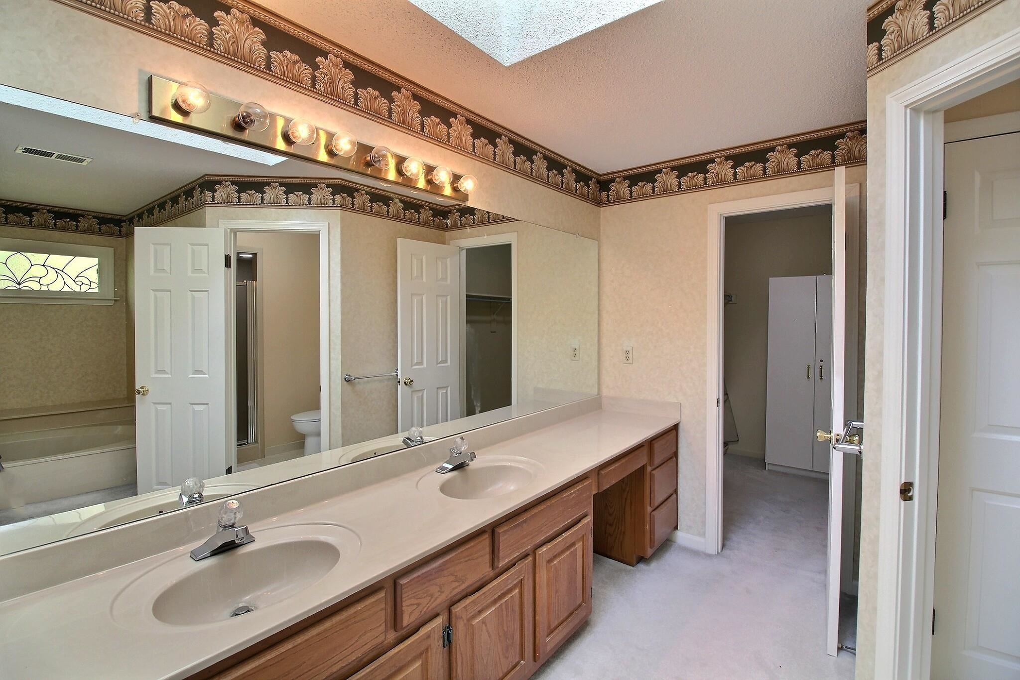 8222 Dogwood Road Germantown, TN 38139 - Photo 26 of 40 a bathroom with a sink double vanity and a mirror