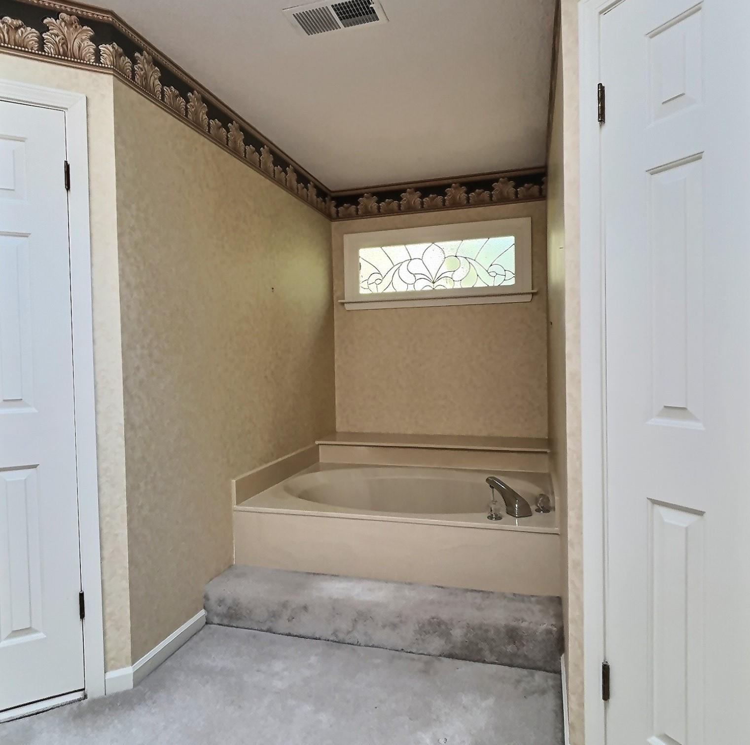 8222 Dogwood Road Germantown, TN 38139 - Photo 27 of 40 a bathroom with a bathtub and a window
