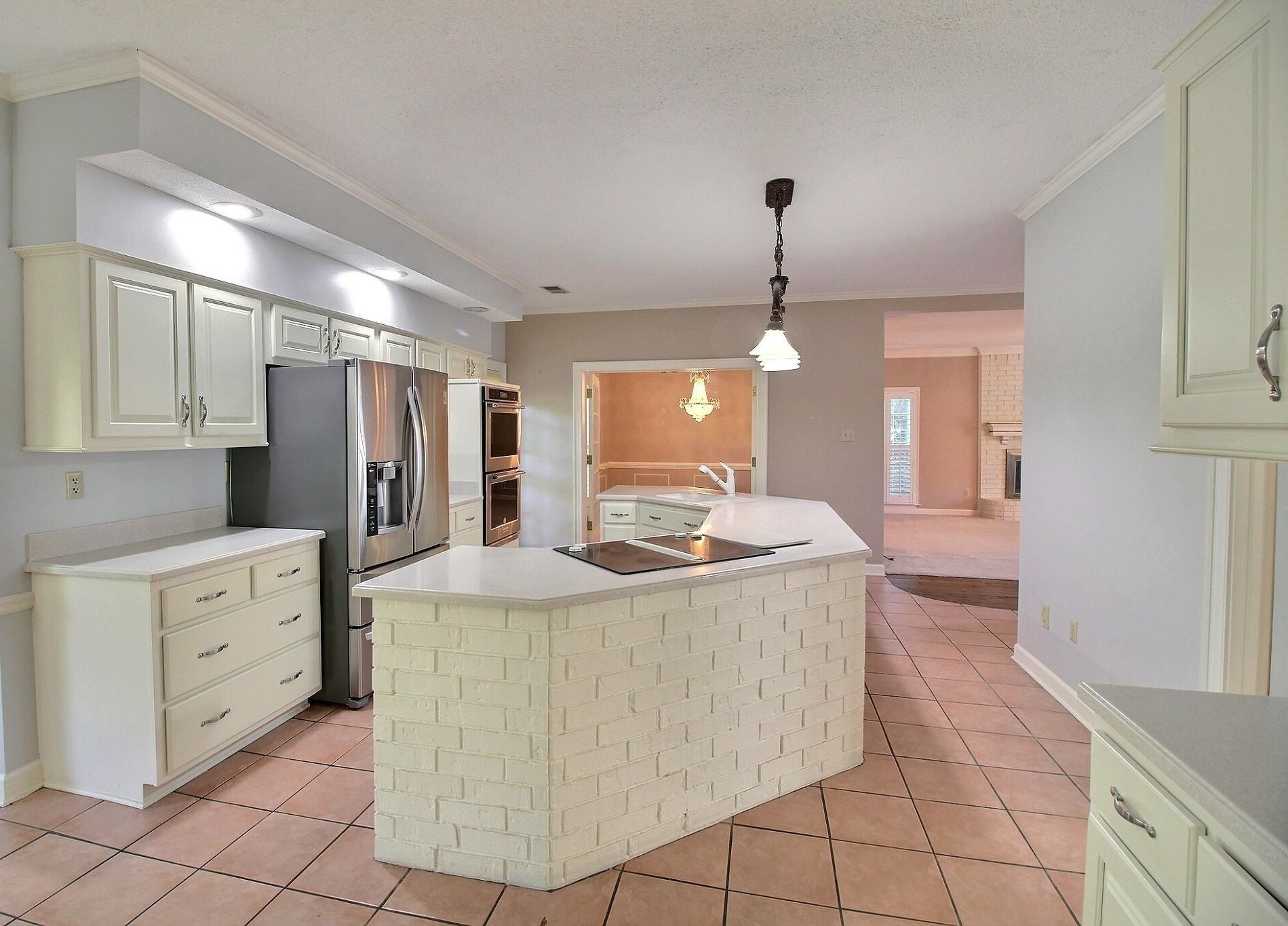 8222 Dogwood Road Germantown, TN 38139 - Photo 8 of 40 a kitchen with kitchen island granite countertop a stove and a sink