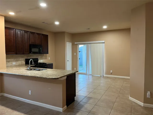 a view of a kitchen with a sink and a window