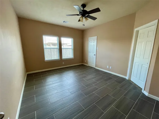 a view of a livingroom with a window and a ceiling fan