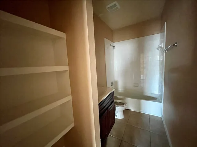 a bathroom with a sink and a glass door shower