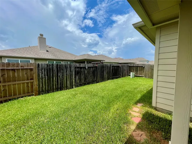 a view of a house with backyard and sitting area