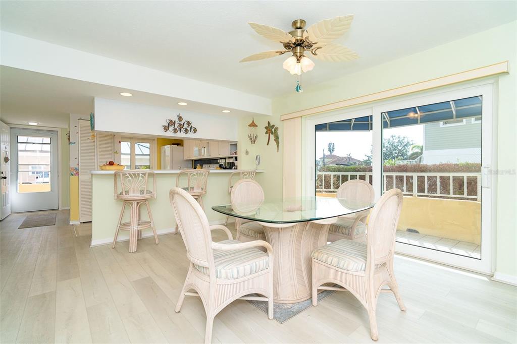 2424 Placida Road, Unit C101 Englewood, FL 34224 - Photo 16 of 65 a dining room with furniture and a floor to ceiling window
