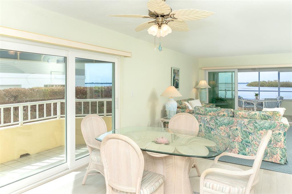 2424 Placida Road, Unit C101 Englewood, FL 34224 - Photo 17 of 65 a view of a dining room with furniture a chandelier and wooden floor