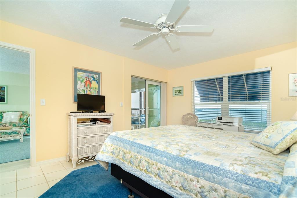 2424 Placida Road, Unit C101 Englewood, FL 34224 - Photo 28 of 65 a bedroom with a bed and a flat screen tv