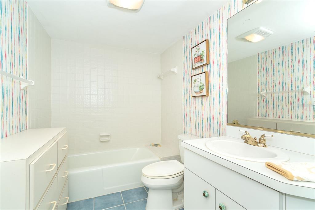 2424 Placida Road, Unit C101 Englewood, FL 34224 - Photo 31 of 65 a bathroom with a sink a toilet and a bathtub