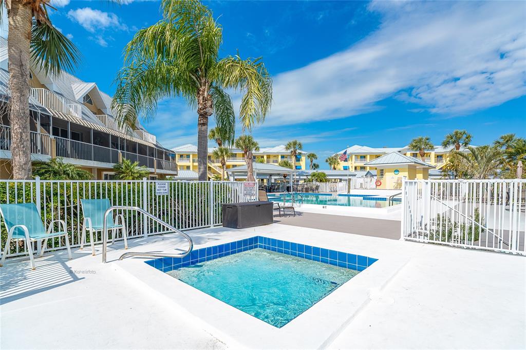 2424 Placida Road, Unit C101 Englewood, FL 34224 - Photo 50 of 65 a view of a swimming pool with a patio and a yard
