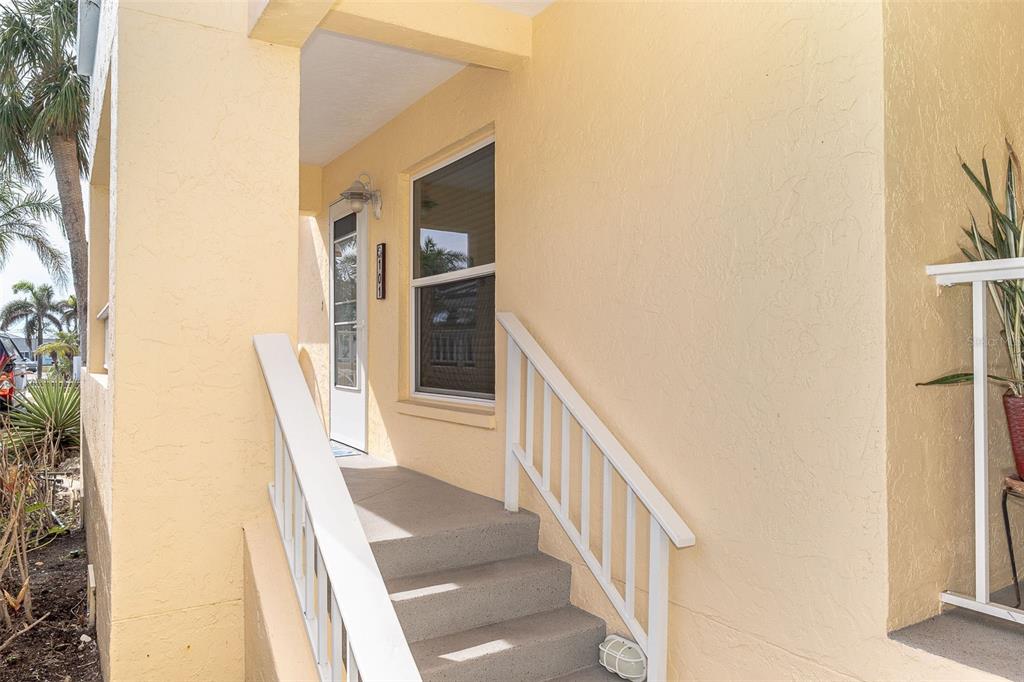 2424 Placida Road, Unit C101 Englewood, FL 34224 - Photo 8 of 65 a view of a hallway with wooden floor and staircase