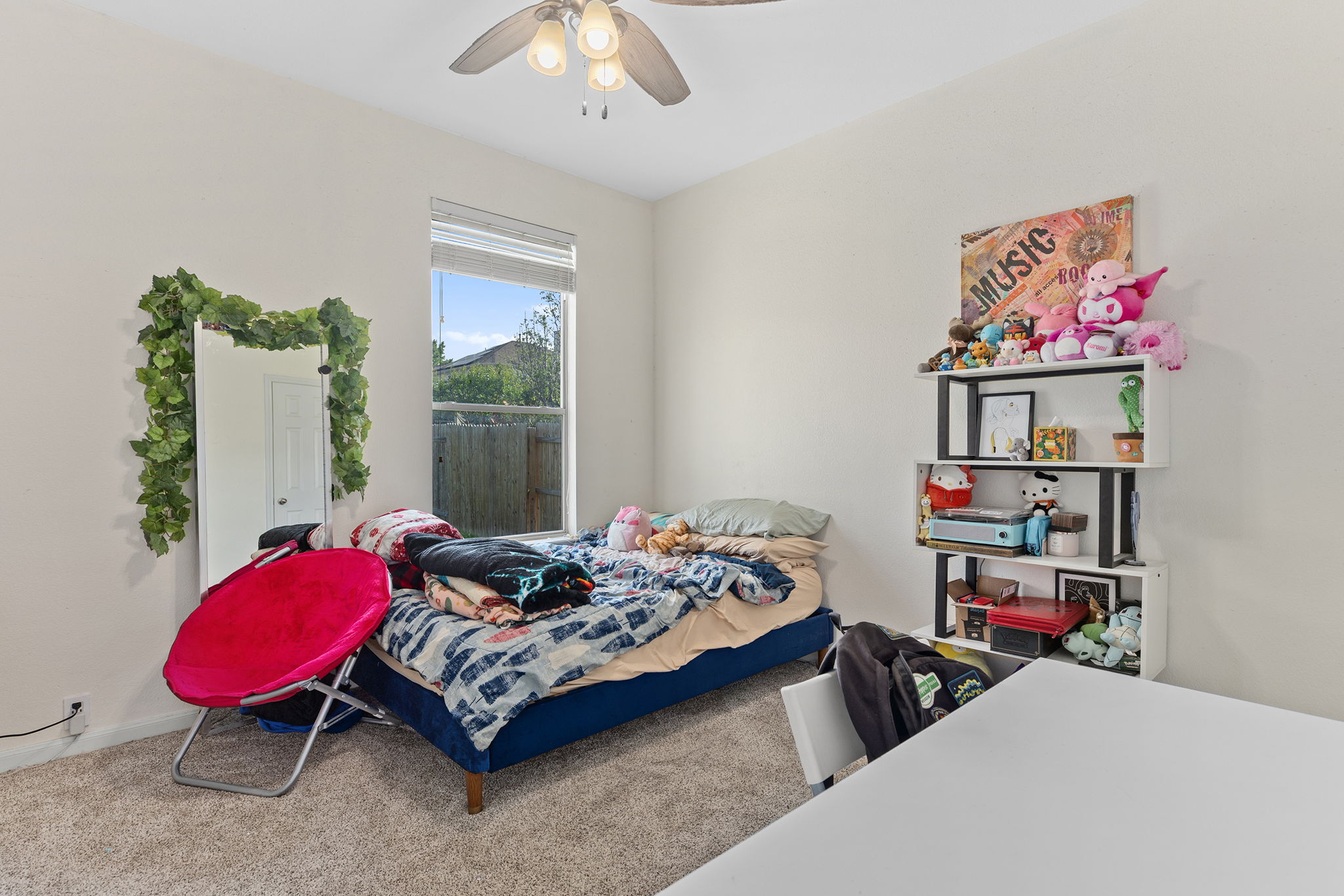 3517 Shiraz Loop Round Rock, TX 78665 - Photo 22 of 40 Carpeted room featuring a ceiling fan with light fixture, a rectangular window with blinds, and light-toned wall finishes