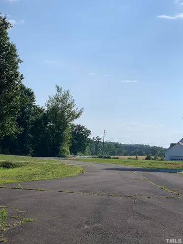 a view of a field and trees