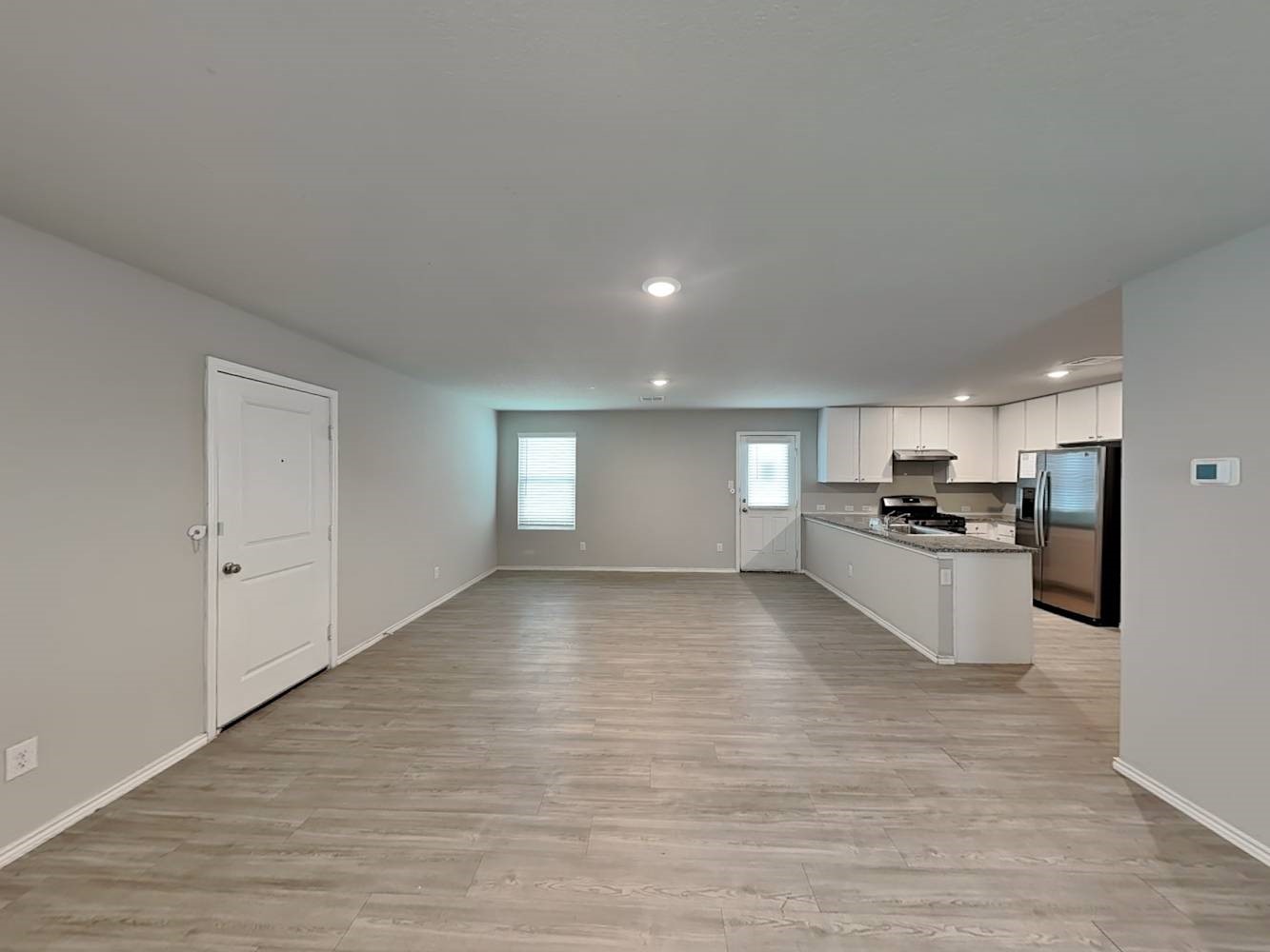 14927 Watson Mill San Antonio, TX 78254 - Photo 3 of 16 a view of a kitchen with kitchen island a sink wooden floor and stainless steel appliances