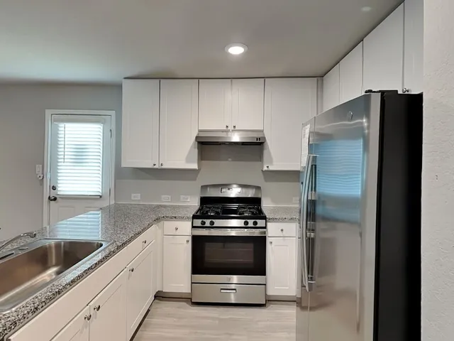 a kitchen with a refrigerator and a sink