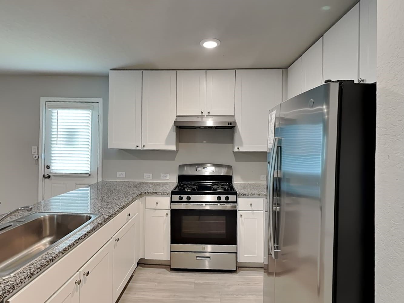 14927 Watson Mill San Antonio, TX 78254 - Photo 5 of 16 a kitchen with a refrigerator and a sink