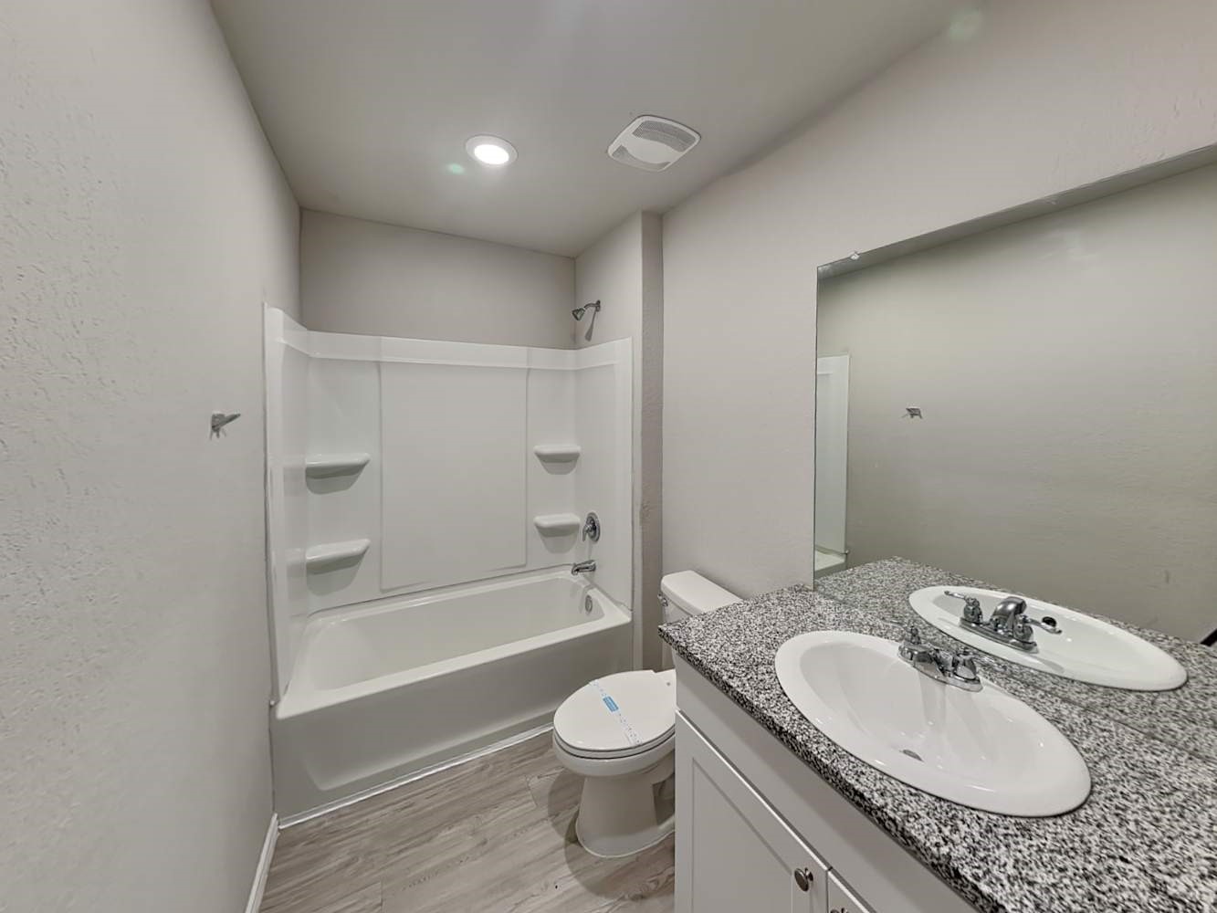 14927 Watson Mill San Antonio, TX 78254 - Photo 9 of 16 a bathroom with a granite countertop sink toilet a bathtub and a shower