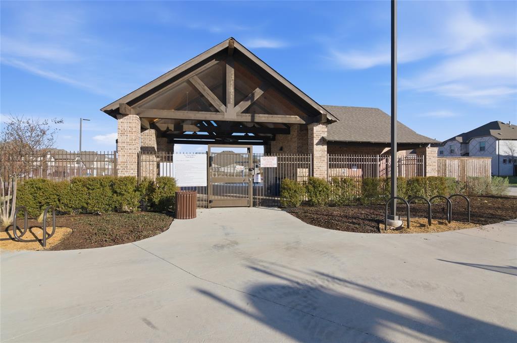 464 LeTara Ranch Drive Haslet, TX 76052 - Photo 37 of 37 Community amenity center featuring a brick and timber-frame pavilion, iron fencing, and manicured landscaping