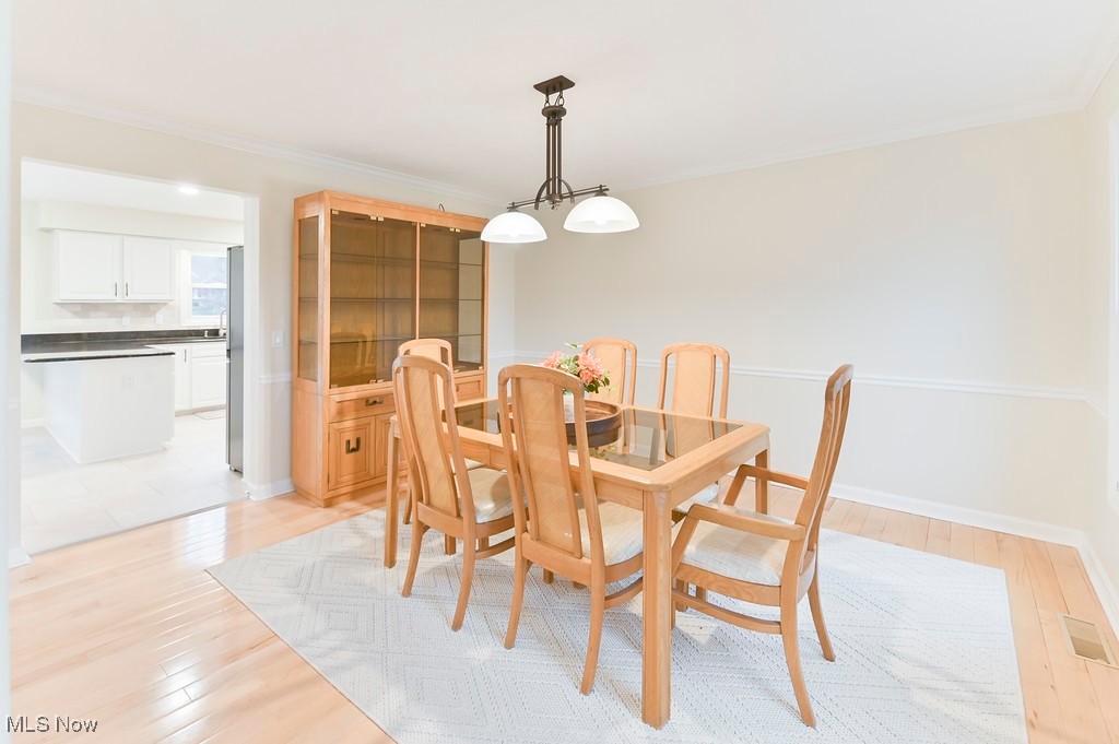 482 Longspur Road Highland Heights, OH 44143 - Photo 20 of 47 Dining room with light wood-style flooring, ornamental molding, baseboards, and visible vents