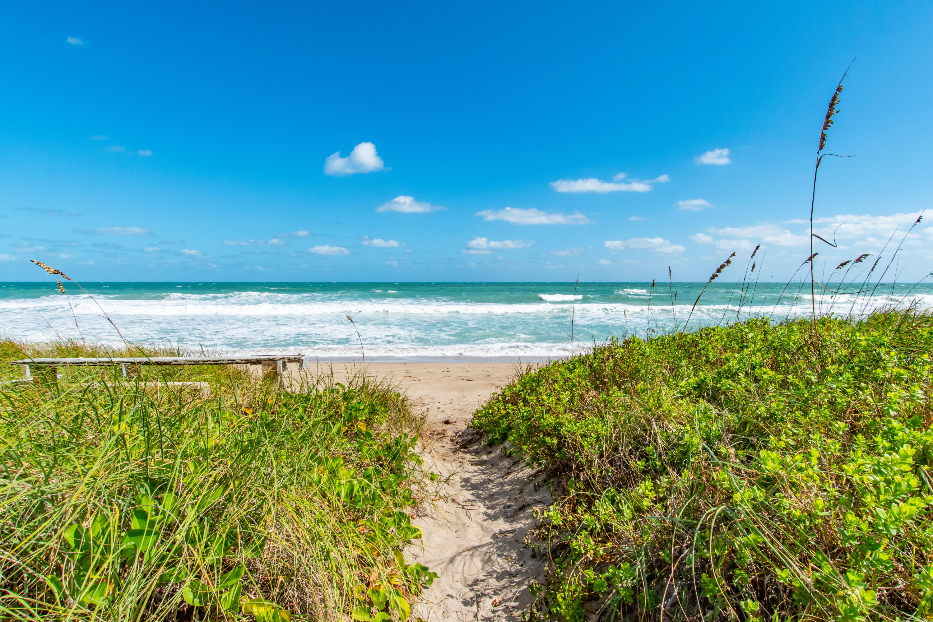 4440 Northeast Sandpebble Trace, Unit 104 Stuart, FL 34996 - Photo 12 of 33 a view of a swimming pool with an outdoor space and seating area