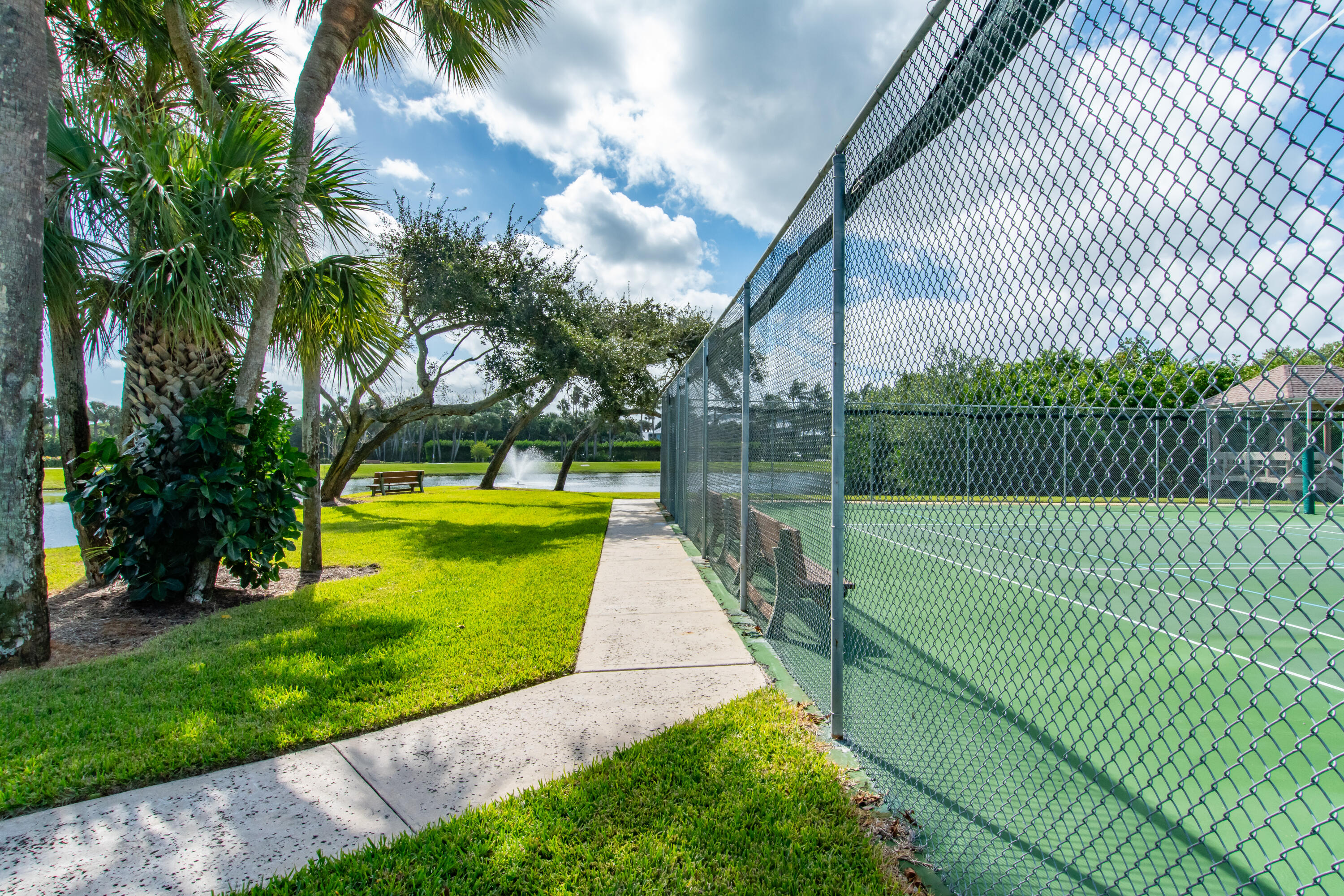 4440 Northeast Sandpebble Trace, Unit 104 Stuart, FL 34996 - Photo 13 of 33 a view of a park with large trees