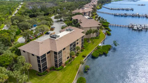 an aerial view of a house with outdoor space and a lake view