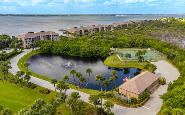 an aerial view of a house with a swimming pool and outdoor seating