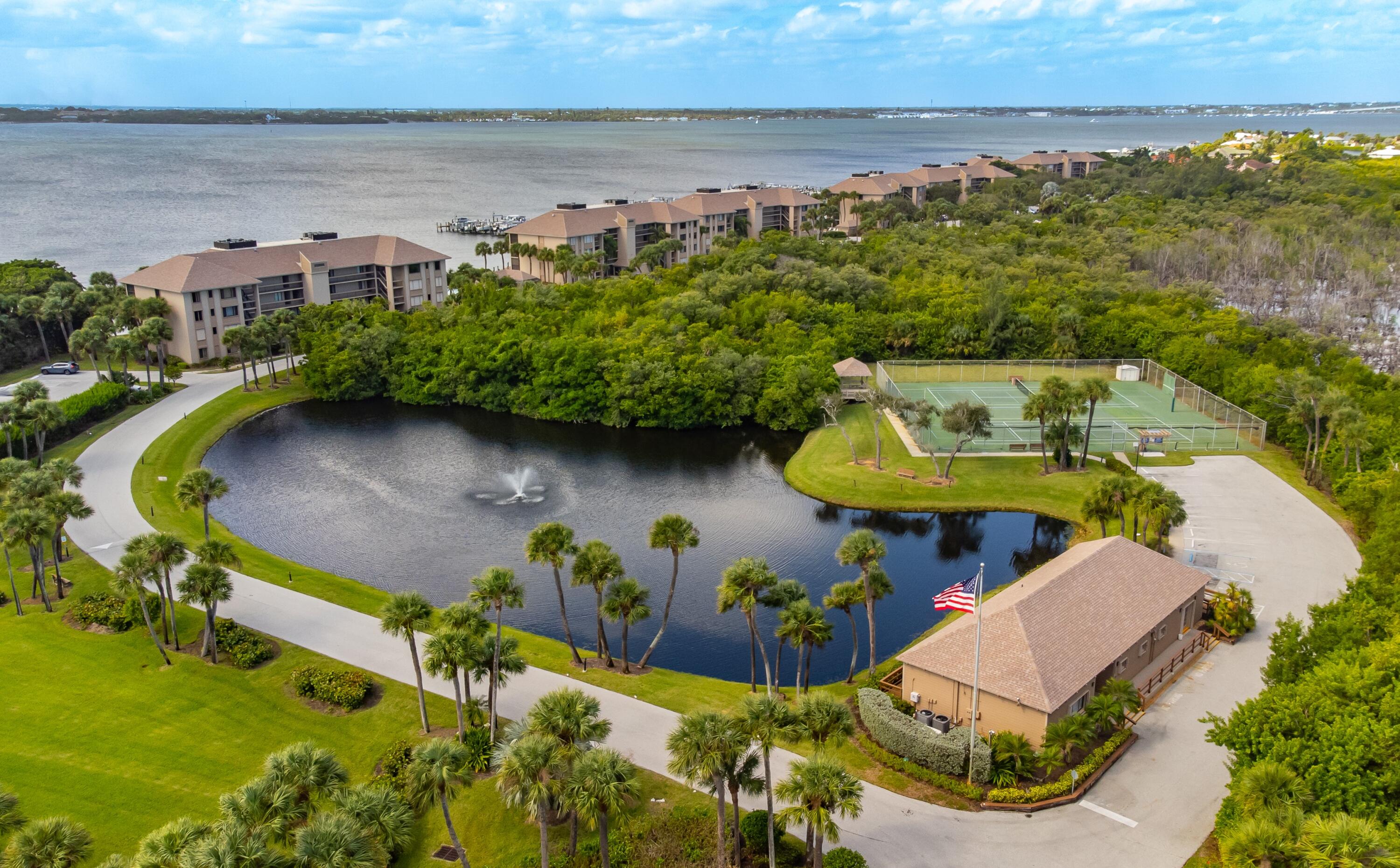 4440 Northeast Sandpebble Trace, Unit 104 Stuart, FL 34996 - Photo 20 of 33 an aerial view of a house with a swimming pool and outdoor seating