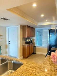 a kitchen with stainless steel appliances granite countertop a sink and a stove