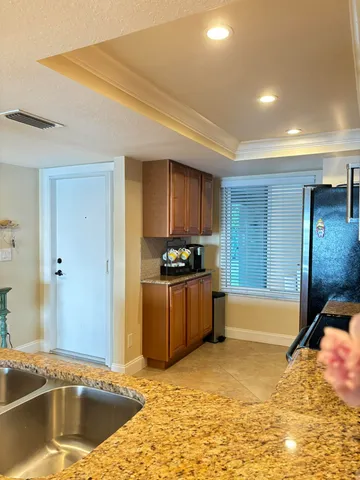a kitchen with stainless steel appliances granite countertop a sink and a stove