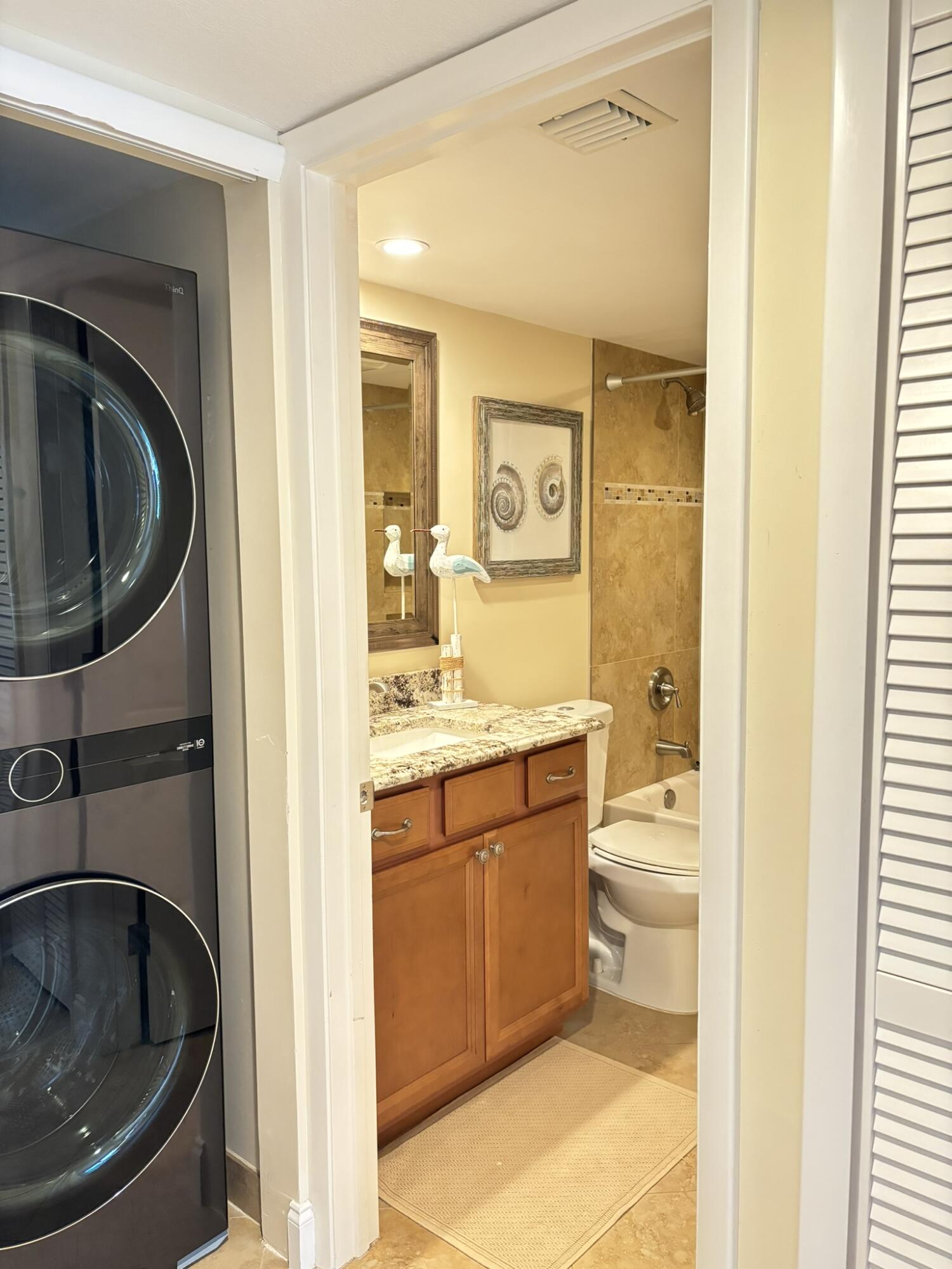 4440 Northeast Sandpebble Trace, Unit 104 Stuart, FL 34996 - Photo 22 of 33 a bathroom with a sink a toilet and a mirror