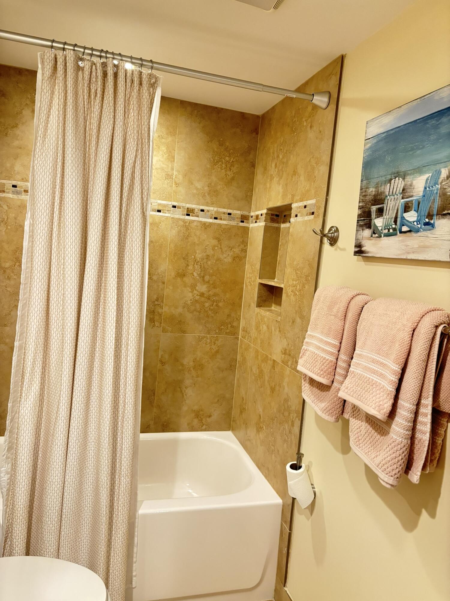 4440 Northeast Sandpebble Trace, Unit 104 Stuart, FL 34996 - Photo 24 of 33 a bathroom with a sink and a shower