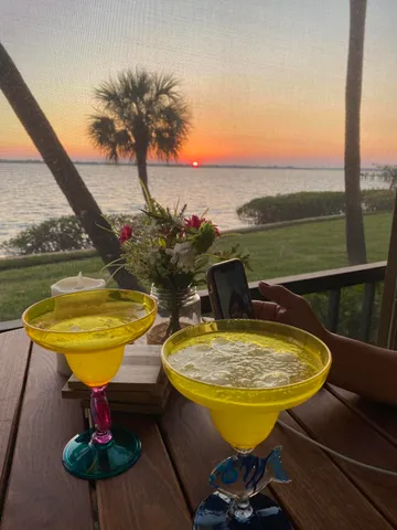 a view of a swimming pool with a table and chairs