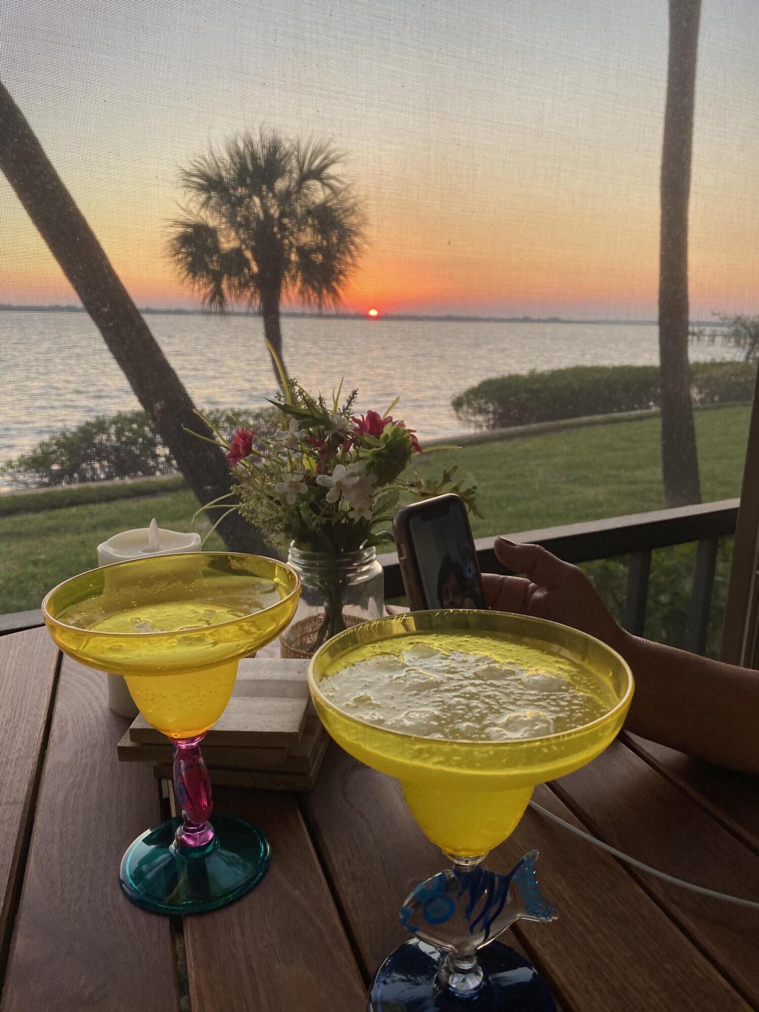 4440 Northeast Sandpebble Trace, Unit 104 Stuart, FL 34996 - Photo 26 of 33 a view of a swimming pool with a table and chairs